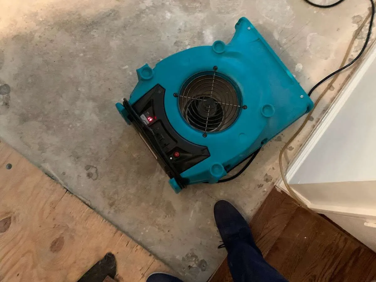 Air mover drying subfloor during Leak Detection & Repair in Wakefield
